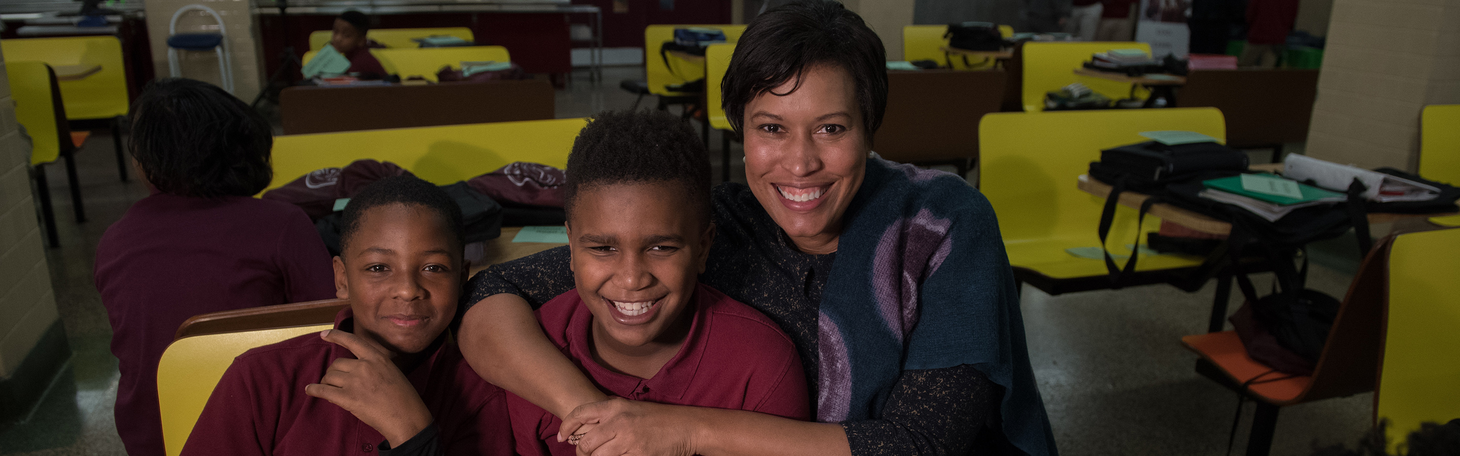 Mayor Bowser hugging kids in their classroom